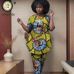 Woman wearing a colorful African print outfit in a room with decor elements.