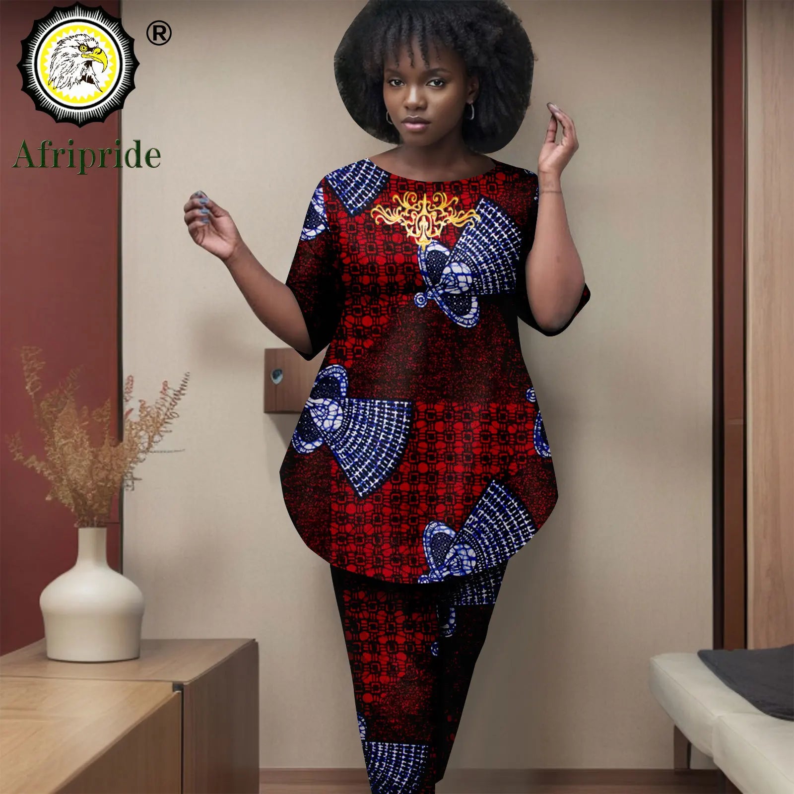 Woman wearing a colorful traditional outfit with 'Afripride' branding in the corner.